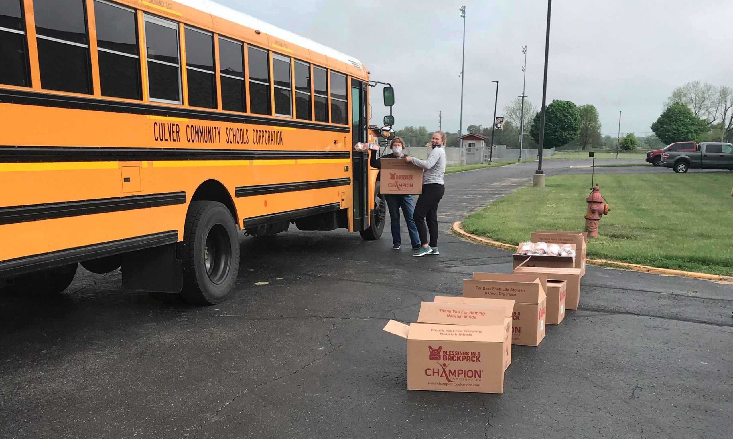 Back-to-School-scaled Volunteer handing food to a recipient